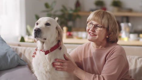 Portrait-of-Happy-Senior-woman-Petting-Dog-at-Home